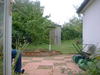 Garden, with someone's knee just visible